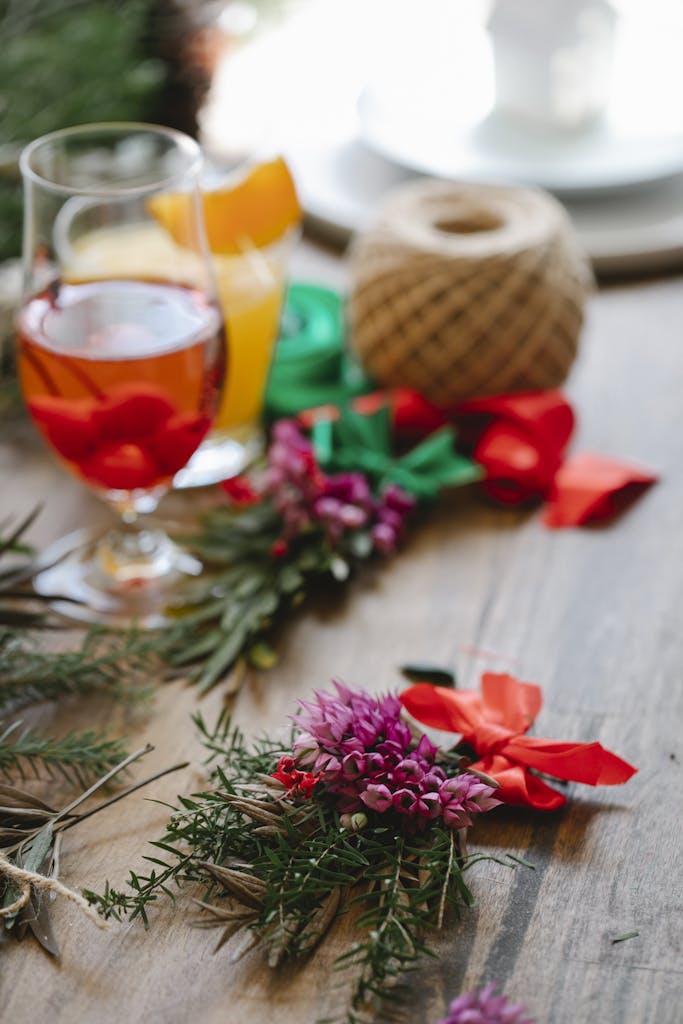 Colorful festive setup with drinks, floral decor, and vibrant ribbons in an indoor setting.