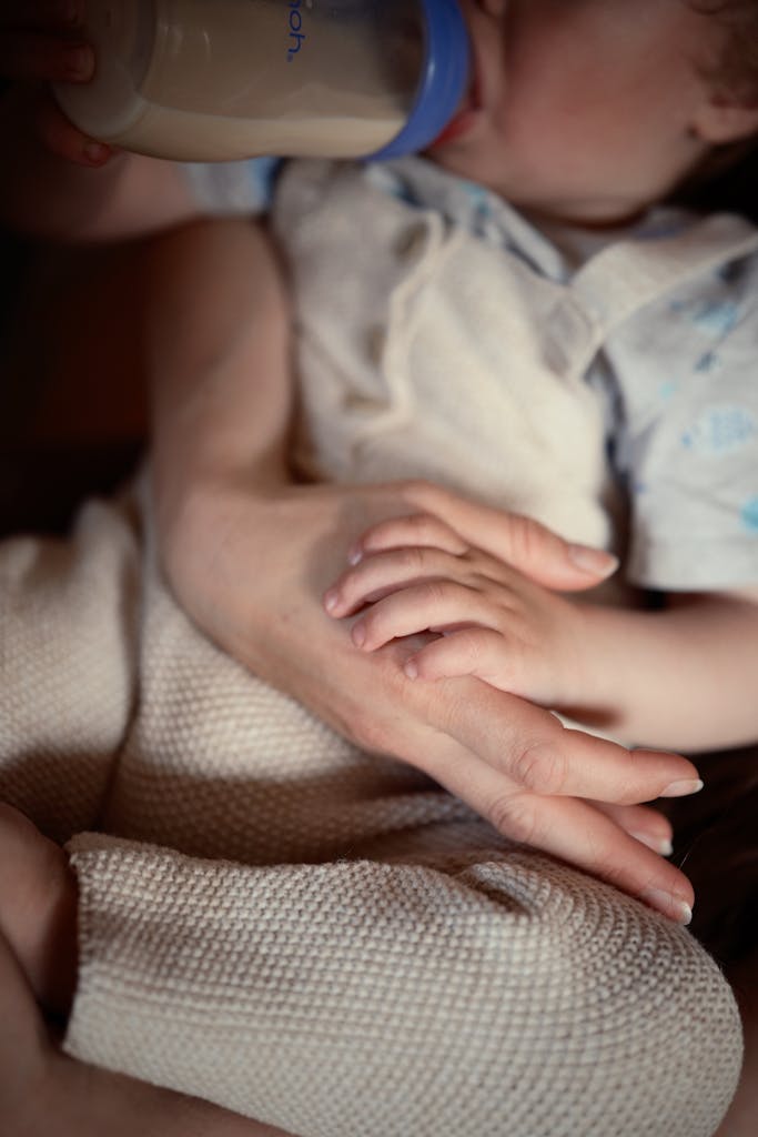 Close-up of a baby holding a parent's hand, conveying love and connection.