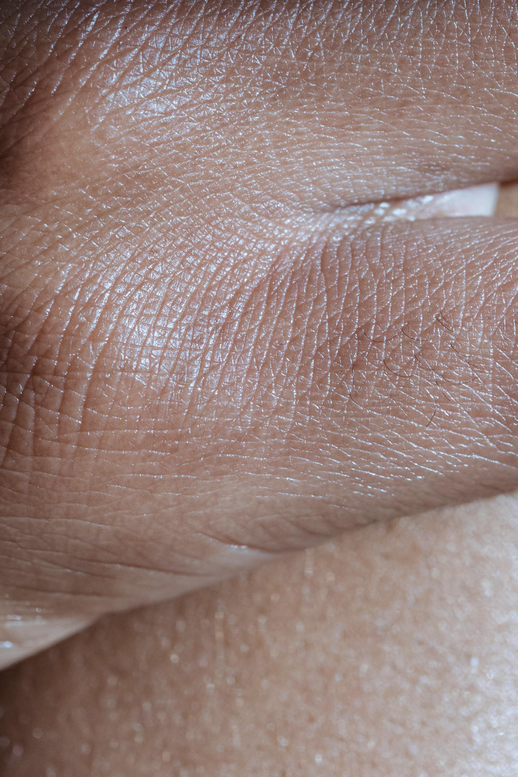 Detailed close-up photo highlighting the texture and smoothness of human skin with visible wrinkles.