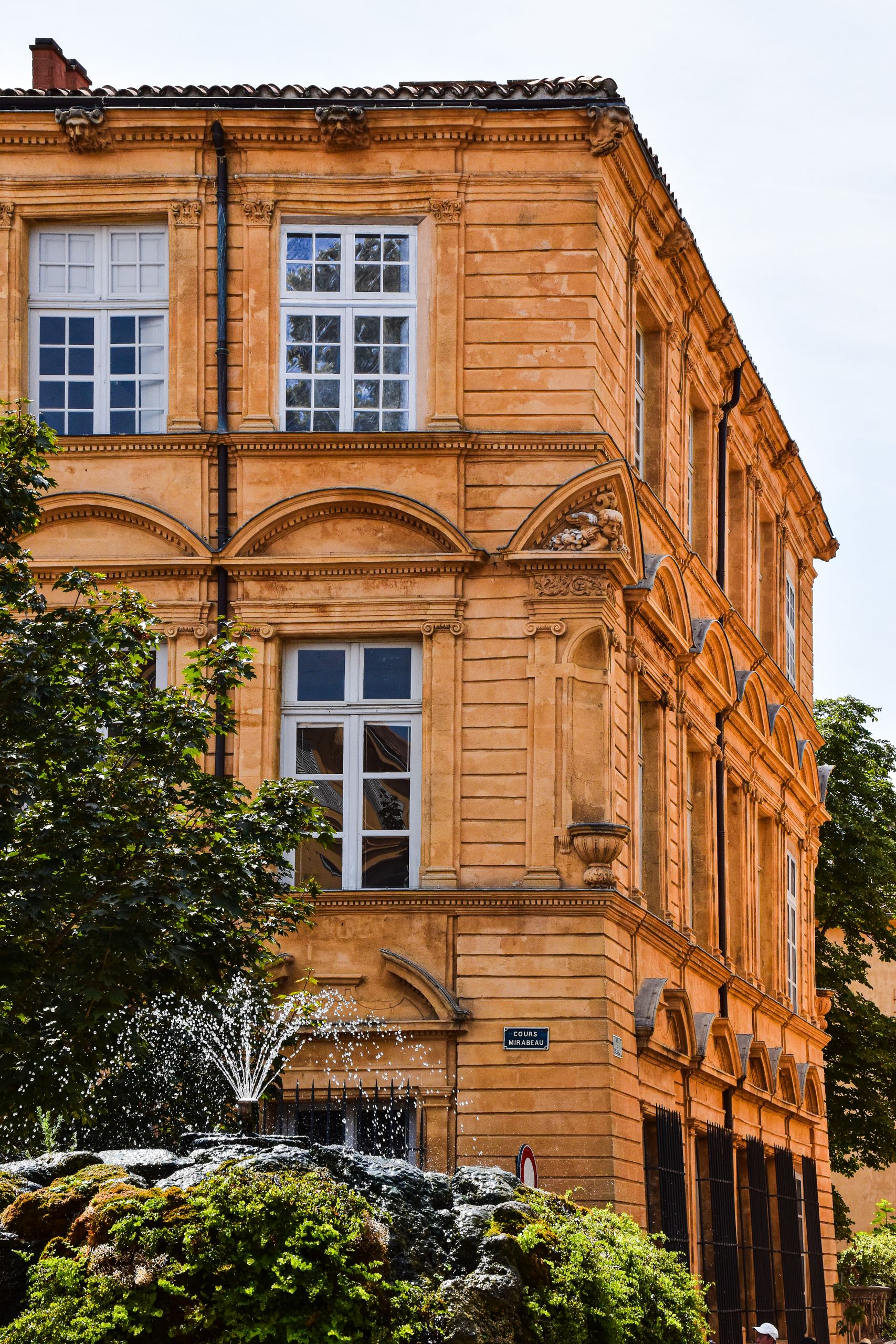 Beautiful historic building with a fountain in Aix-en-Provence, France, highlighting local architecture.