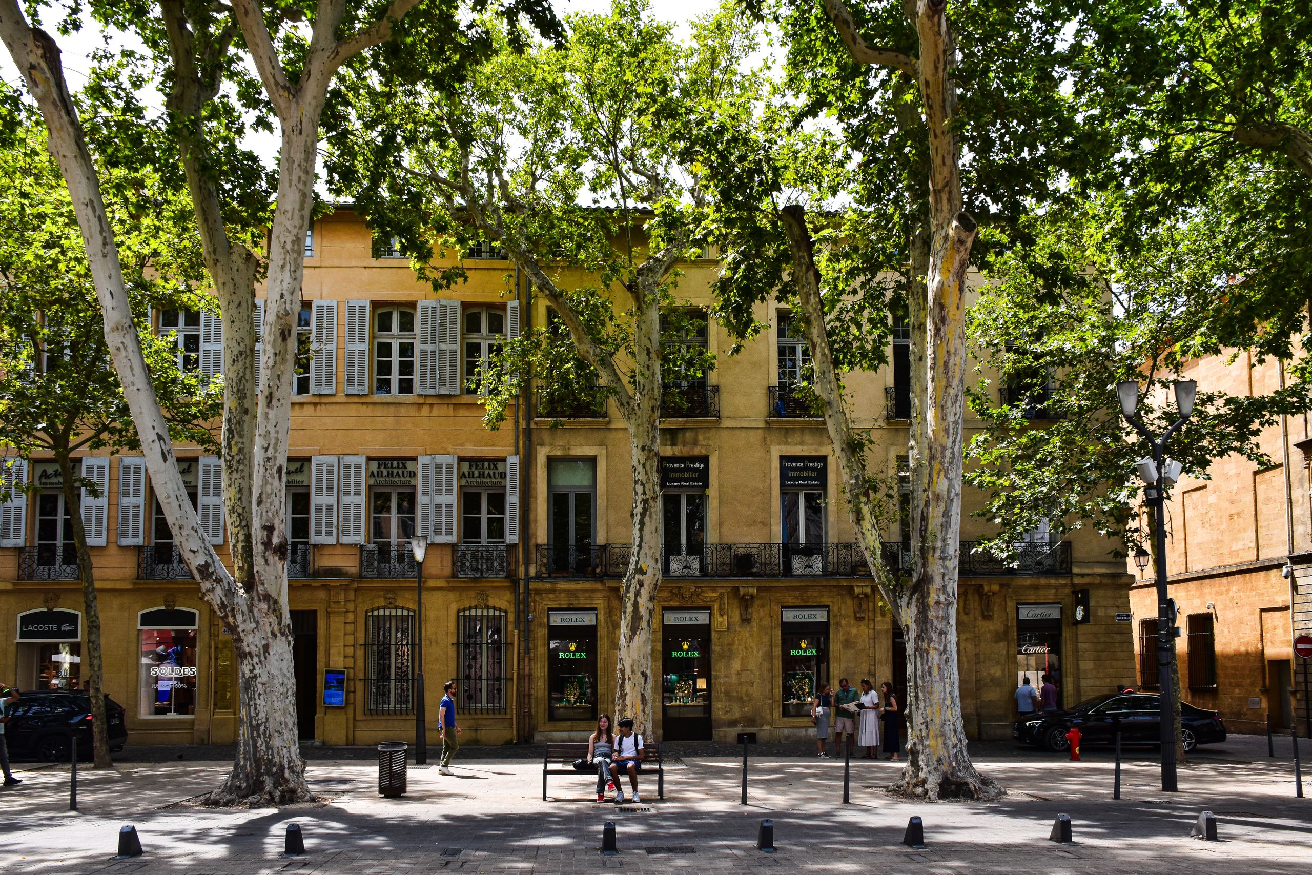 Picturesque view of a tree-lined street in Aix-en-Provence, showcasing classic architecture.